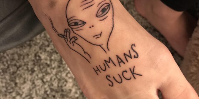 “Humans Suck” alien smoking a joint by Eric at American Tattoo San Diego in San Diego, CA